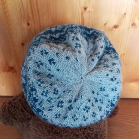 Hand knitted woollen beanie with dark and light blue pattern detail