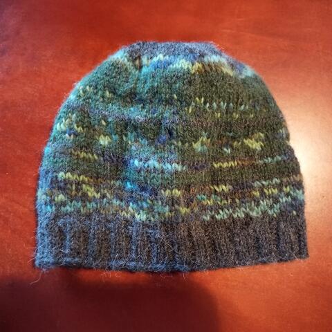 Knitted woollen beanie with green, blue and grey details